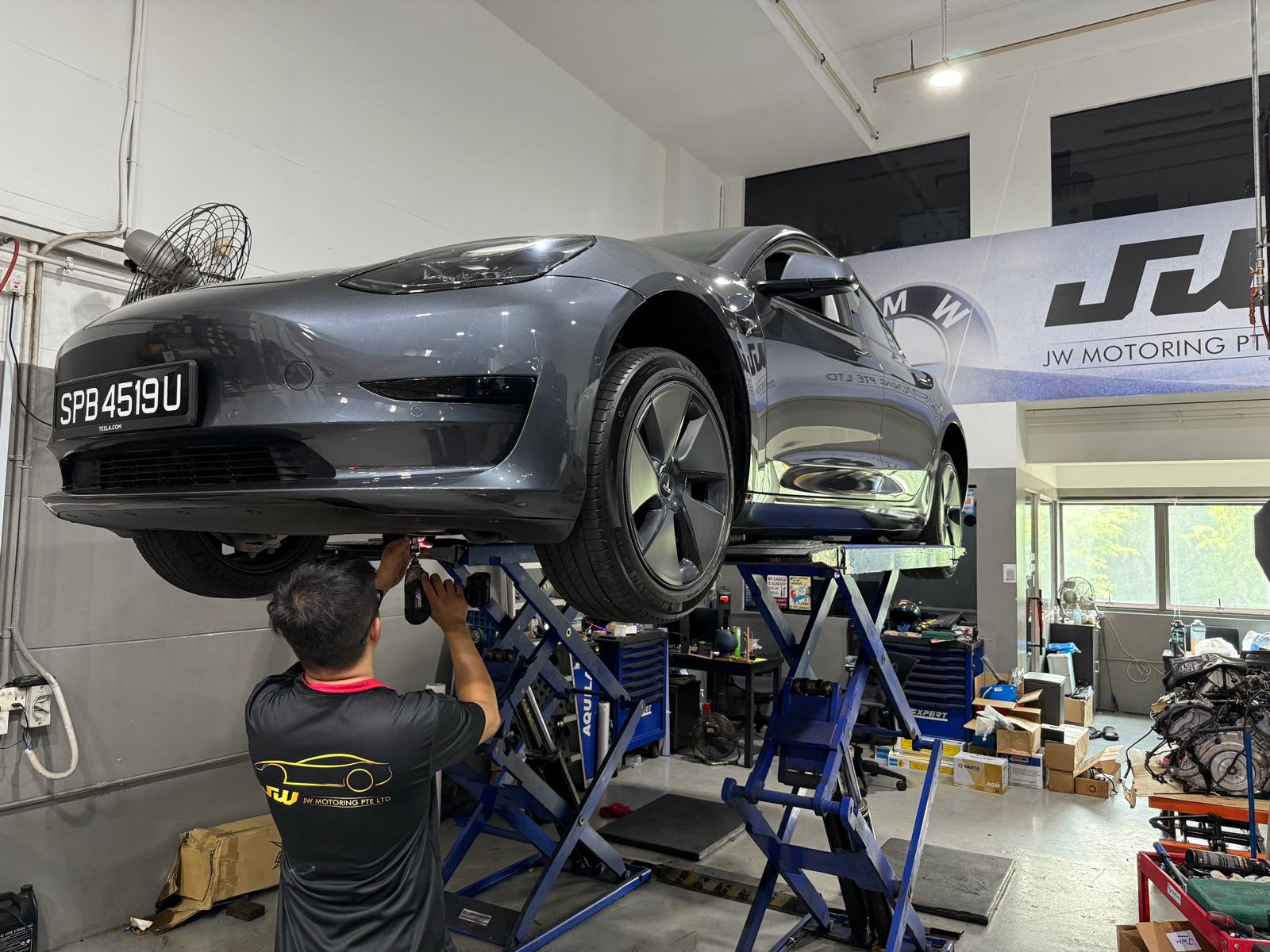 Tesla Model 3 — EV service bay work